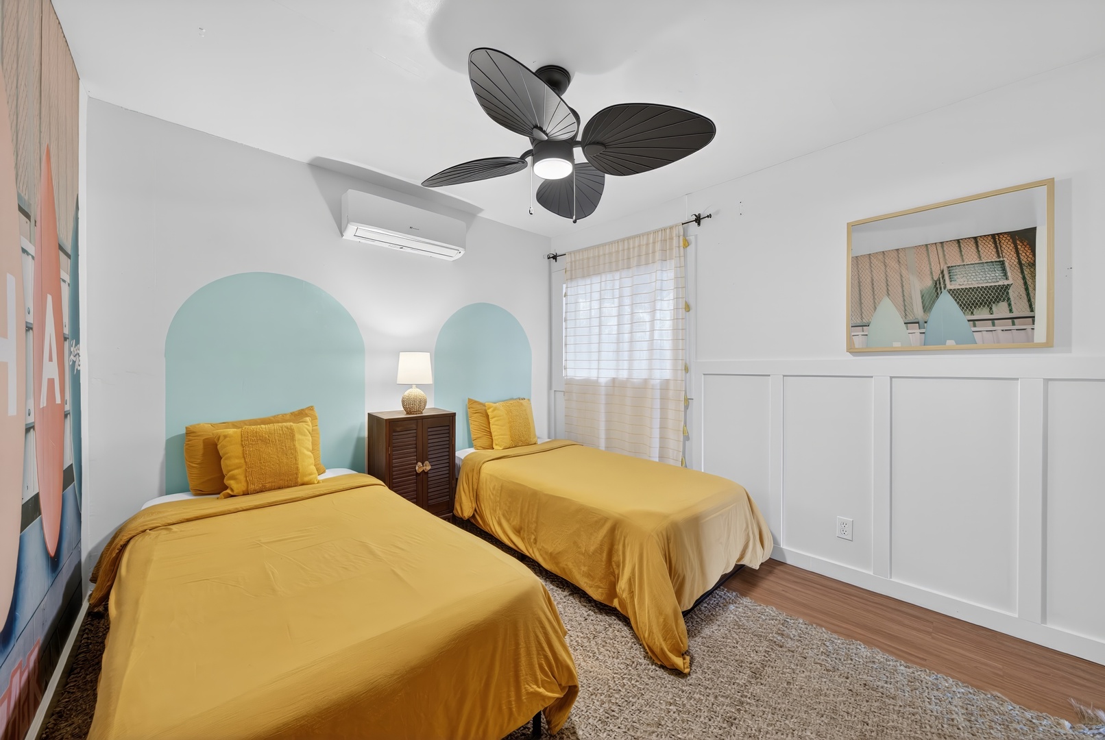 Laie Vacation Rentals, Dolphin House - Cozy twin bedroom with surf-inspired wall art, creating a fun and relaxing beachside retreat.
