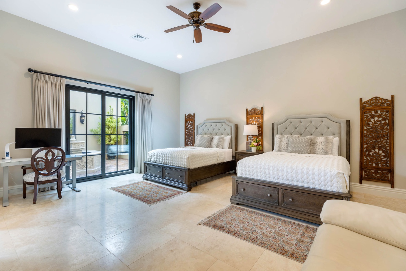 Honolulu Vacation Rentals, The Kahala Mansion Event Venue - Spacious bedroom with two beds, a ceiling fan, and patio access for ultimate comfort.