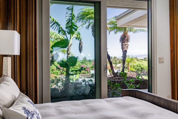 Kamuela Vacation Rentals, Canoe House & Beach Walker at Champion Ridge - Bedroom with a beautiful view of lush tropical plants, offering a peaceful and serene connection to nature.