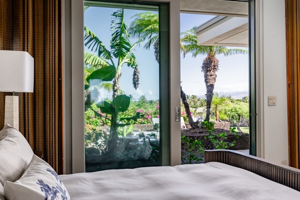 Kamuela Vacation Rentals, Champion Ridge 22 & 24 - Bedroom with a beautiful view of lush tropical plants, offering a peaceful and serene connection to nature.