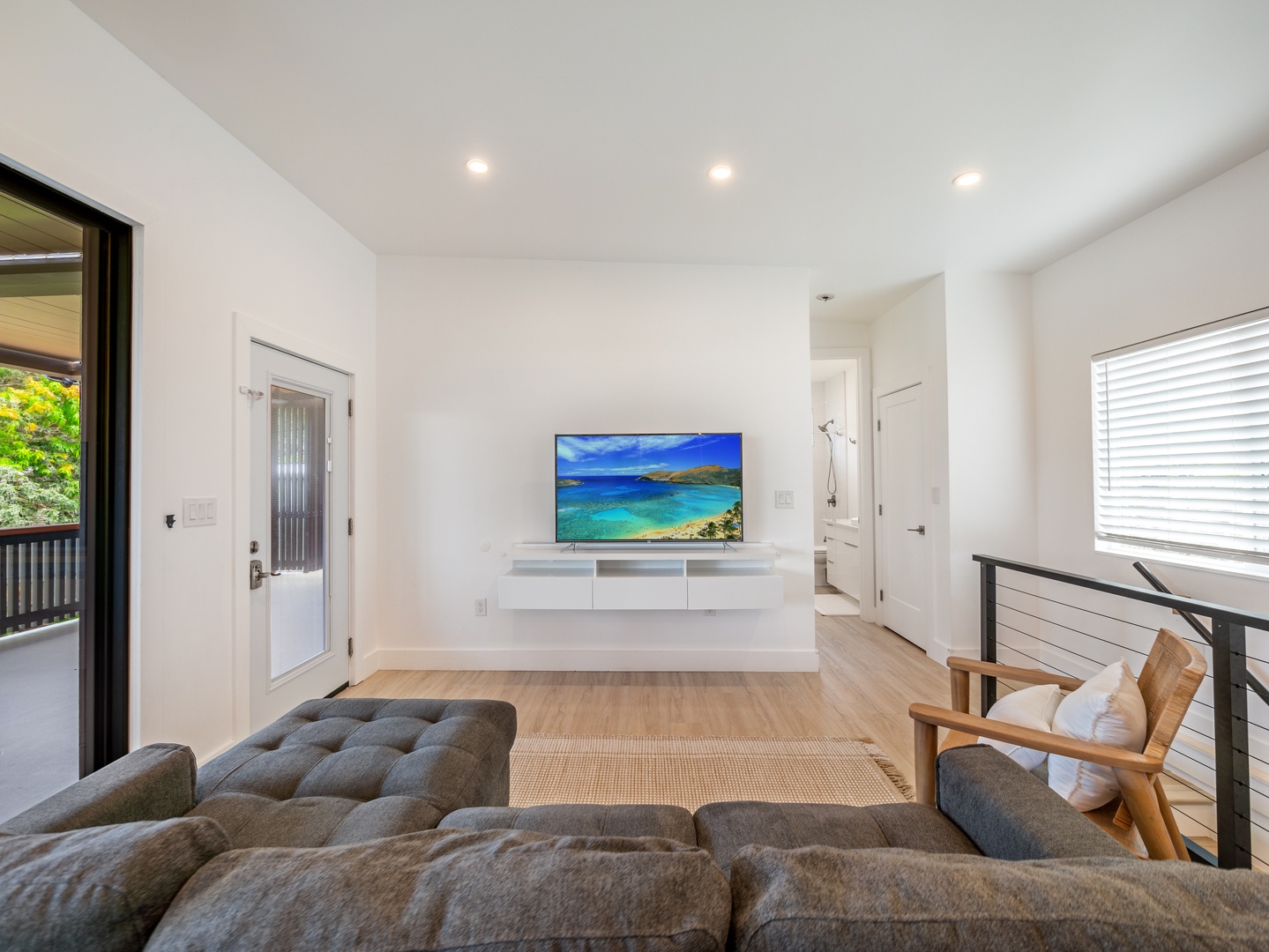 Haleiwa Vacation Rentals, Sunset Beach Island Retreat - The modern living room features a sleek entertainment center with a flat-screen TV, offering the perfect spot to relax and enjoy your favorite shows or movies after a day of adventures