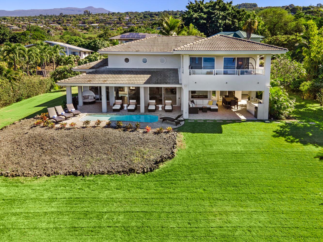 Kailua Kona Vacation Rentals, Ho'okipa Hale - Relaxation awaits in the sun-kissed backyard, complete with a refreshing pool and inviting chaise lounges.