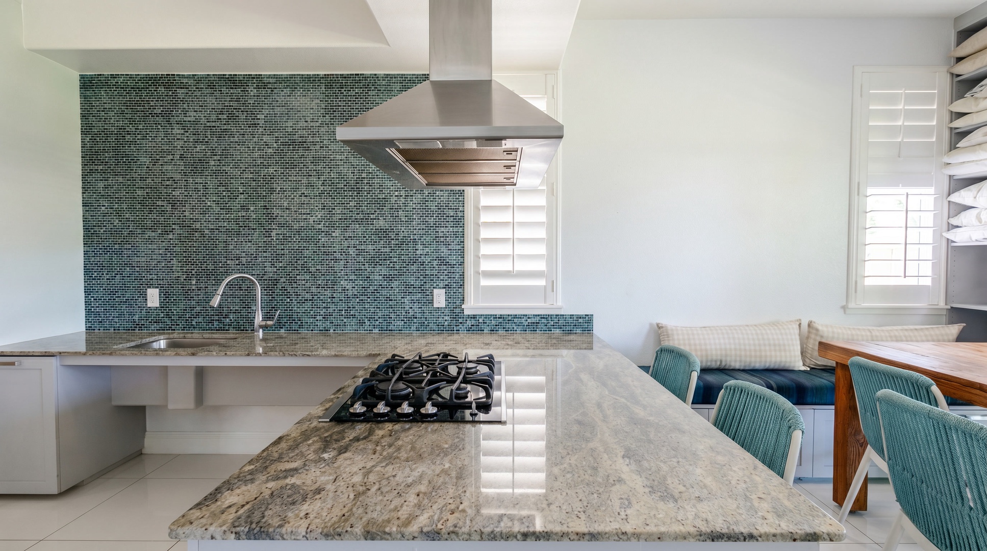Gas cooktop set into the granite island, facing the room instead of a wall.
