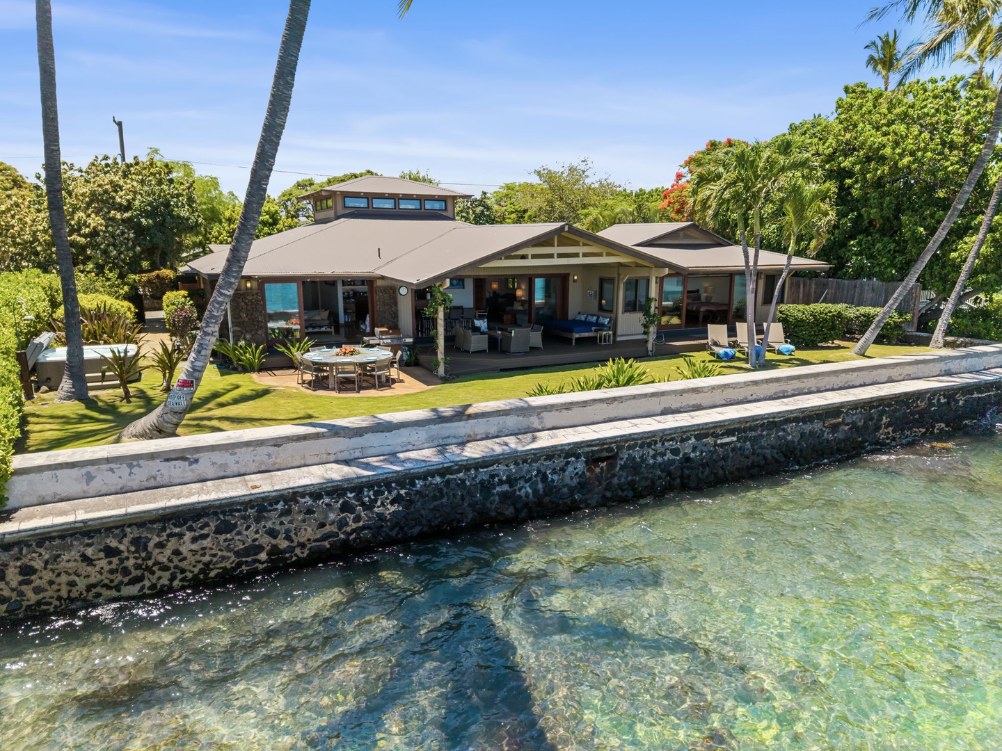 Kamuela Vacation Rentals, Island Time Retreat - The home holds its own point on the coast, seawall wrapping the turquoise water.