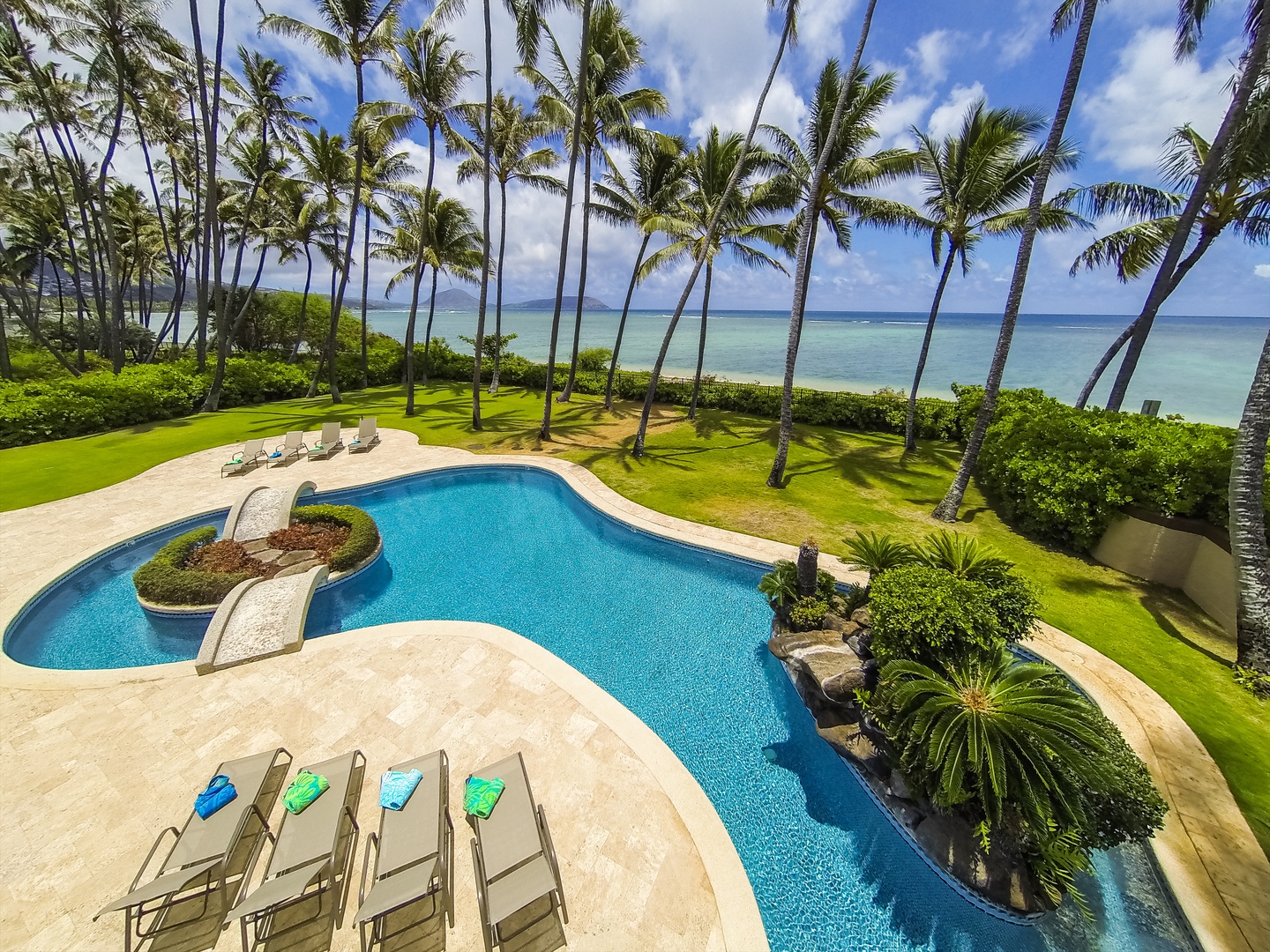 Honolulu Vacation Rentals, Kahala Mini Resort (5BR) - Loungers line the freeform pool where it curls along the ocean side of the lawn.