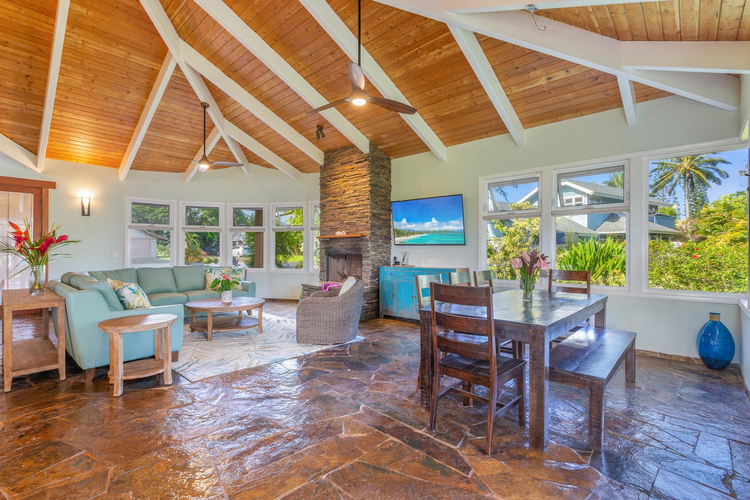 Princeville Vacation Rentals, Pohaku Villa - The living room offers bright and airy ambiance with high-vaulted ceiling, TV plush sofas and ceiling fan.