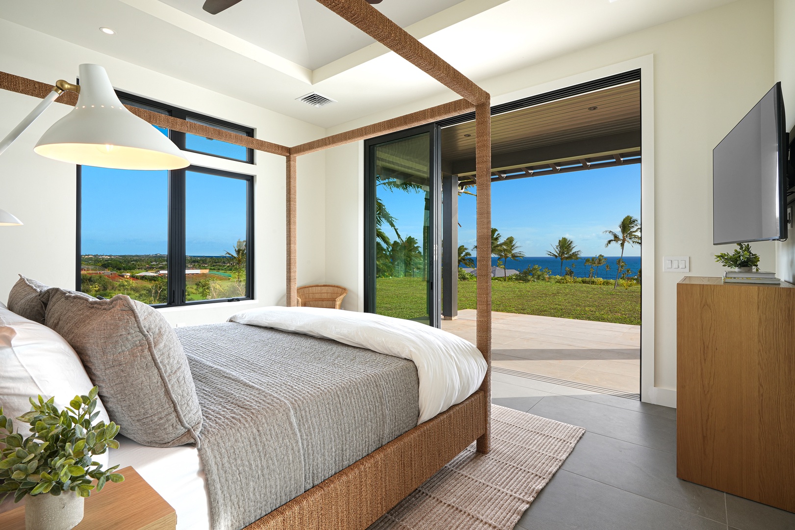 Koloa Vacation Rentals, Hiki Moe Hale - Luxurious primary bedroom with a king-size bed and direct access to a serene outdoor view.