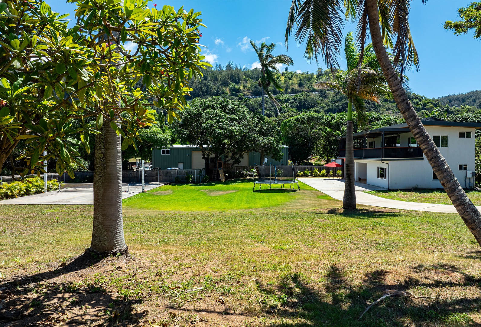 Haleiwa Vacation Rentals, Sunset Beach Island Retreat - A spacious backyard with a lush green lawn offers plenty of room for outdoor activities and relaxation.