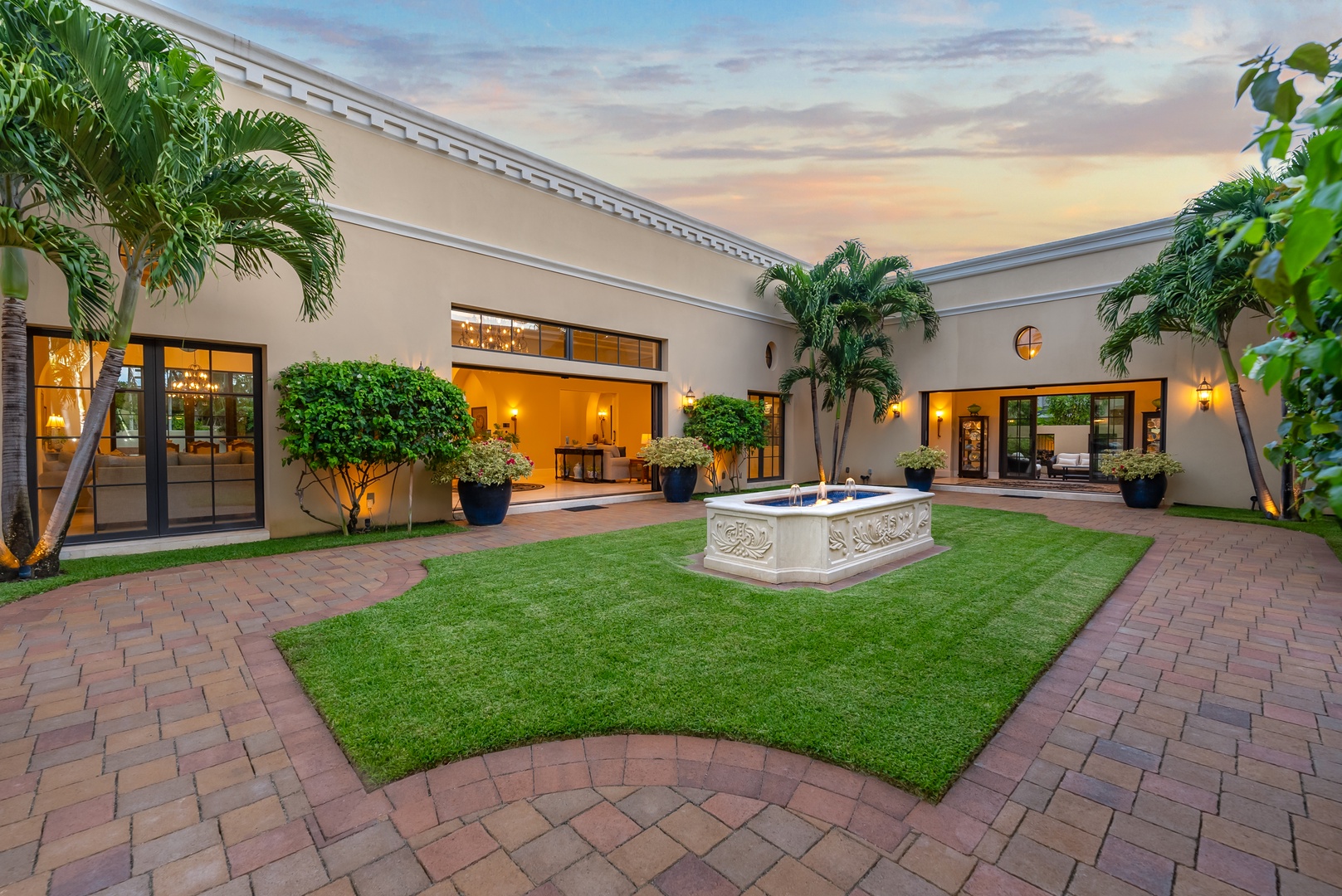 Honolulu Vacation Rentals, The Kahala Mansion - Tranquil courtyard featuring lush greenery, a central fountain, and a serene ambiance for relaxation or gatherings.