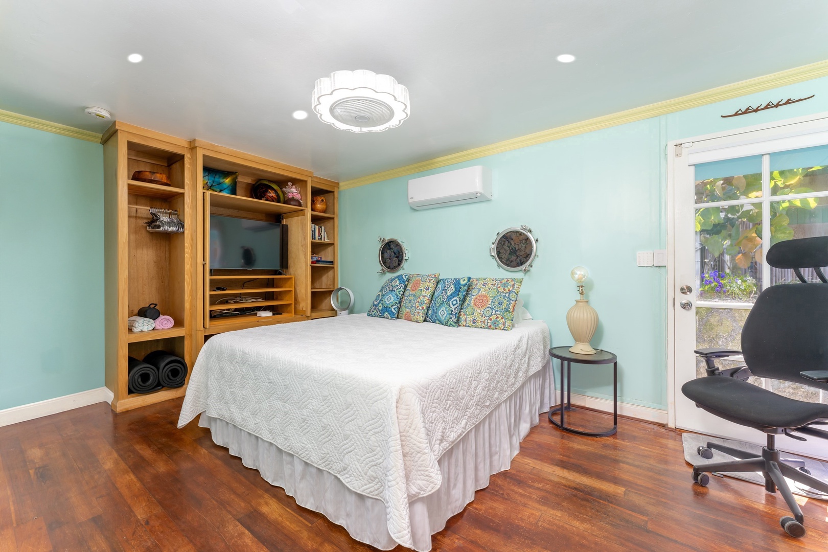 Hauula Vacation Rentals, Private Beach Paradise - Built-in shelves and warm wood floors give this bedroom a settled, lived-in feel.