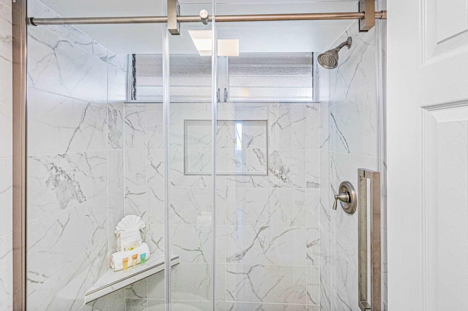 Lahaina Vacation Rentals, Royal Kahana 213 - The bathroom's walk-in shower offers a spa-like experience with marble-style tile, a sleek glass door, and modern fixtures.