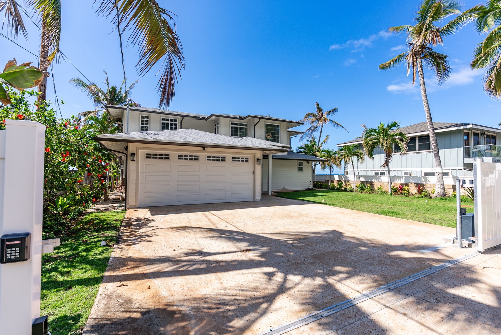 Waianae Vacation Rentals, Oceanfront Luxury Dream Estate - A wide driveway framed by palms leads to the spacious two-car garage and main estate entrance.