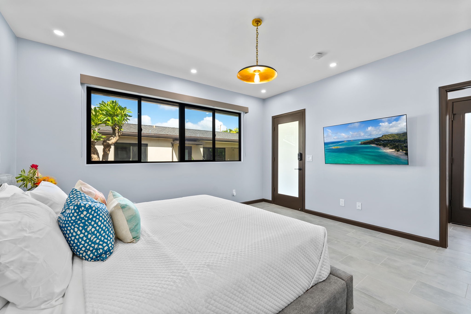 Honolulu Vacation Rentals, Kahala Zen - Luxury bedroom with a king-size bed and a stunning backyard view.