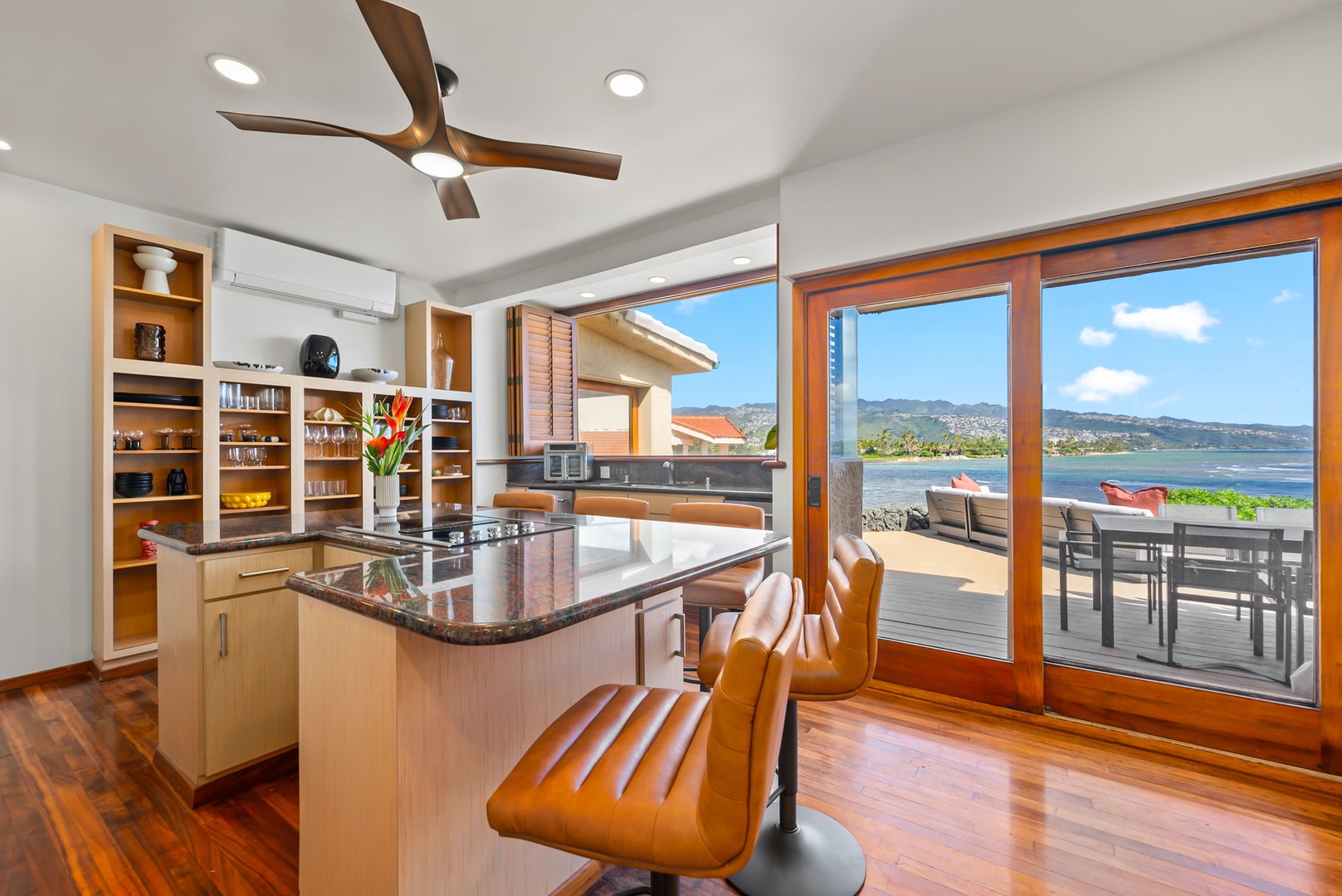Honolulu Vacation Rentals, Black Point Ocean Villa - Stunning ocean views through floor-to-ceiling windows while enjoying your modern kitchen's granite counters and open shelving.