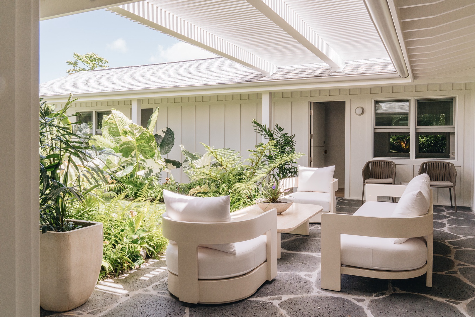 Honolulu Vacation Rentals, Surfside Bungalow** - Open-air living and comfortable seating create a seamless connection to the surrounding gardens.