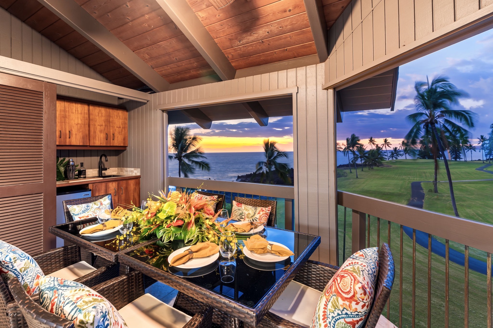 Kailua Kona Vacation Rentals, Kanaloa at Kona 1606 - Evening on the lanai, the coastline glowing gold past the palms.