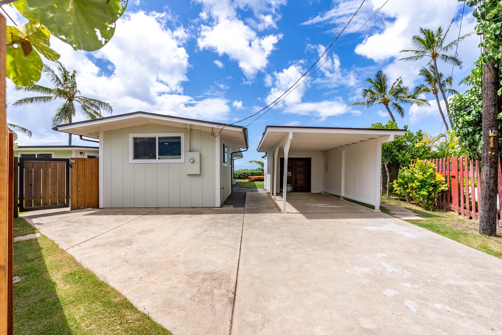 Waialua Vacation Rentals, Mokuleia Beach Villa** - A secured and gated property with a long driveway for extra parking space.