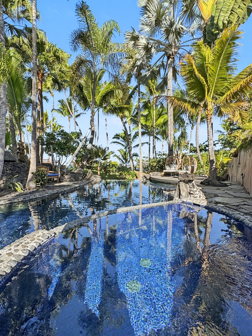 Kailua-Kona Vacation Rentals, Hahalua Bay Villa - Immerse yourself in tropical paradise beside this stunning blue-tiled pool, surrounded by swaying palms and natural stone features.