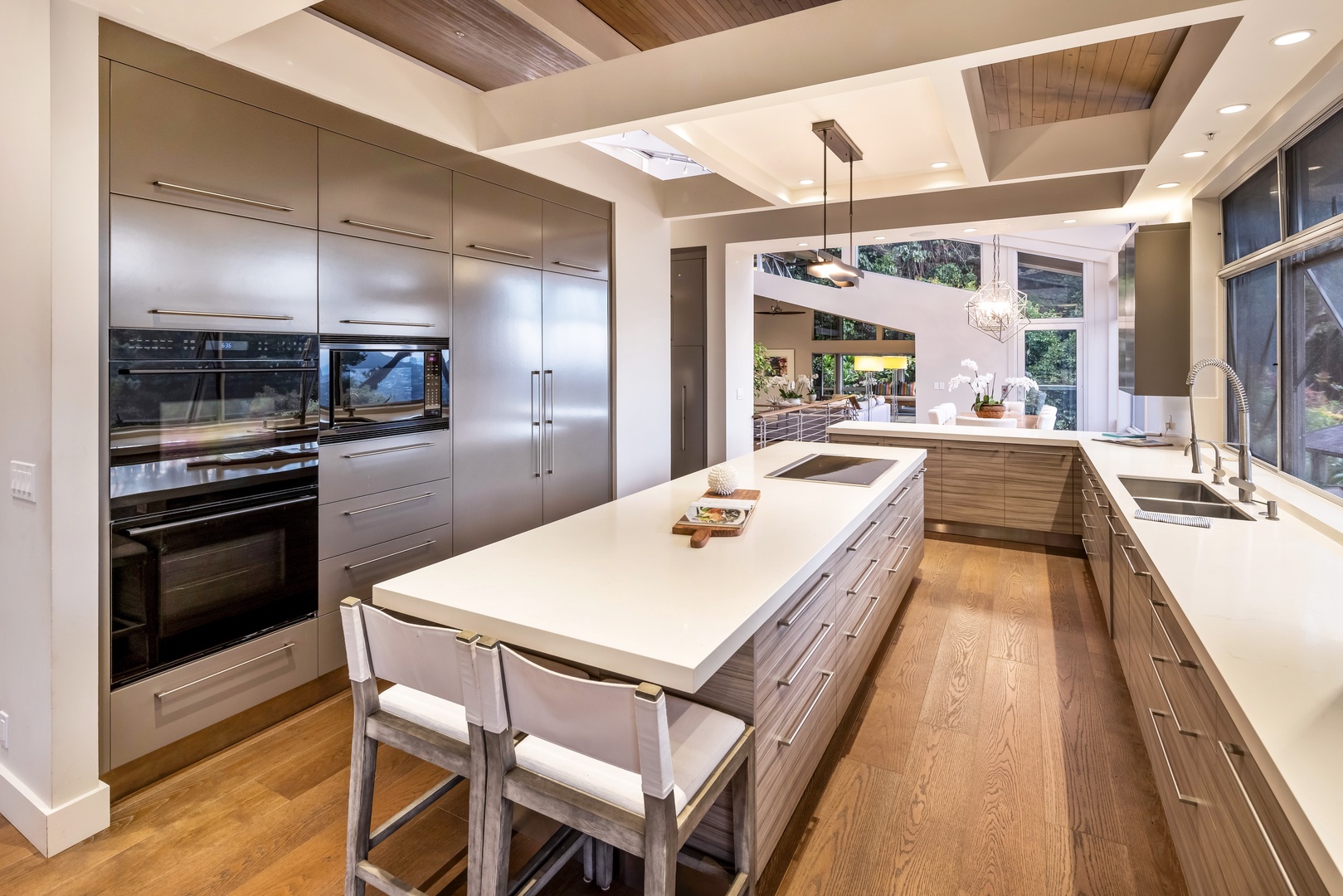 Honolulu Vacation Rentals, Manoa Royal Retreat - Chef’s kitchen with oversized island, high-end appliances, and panoramic garden views.
