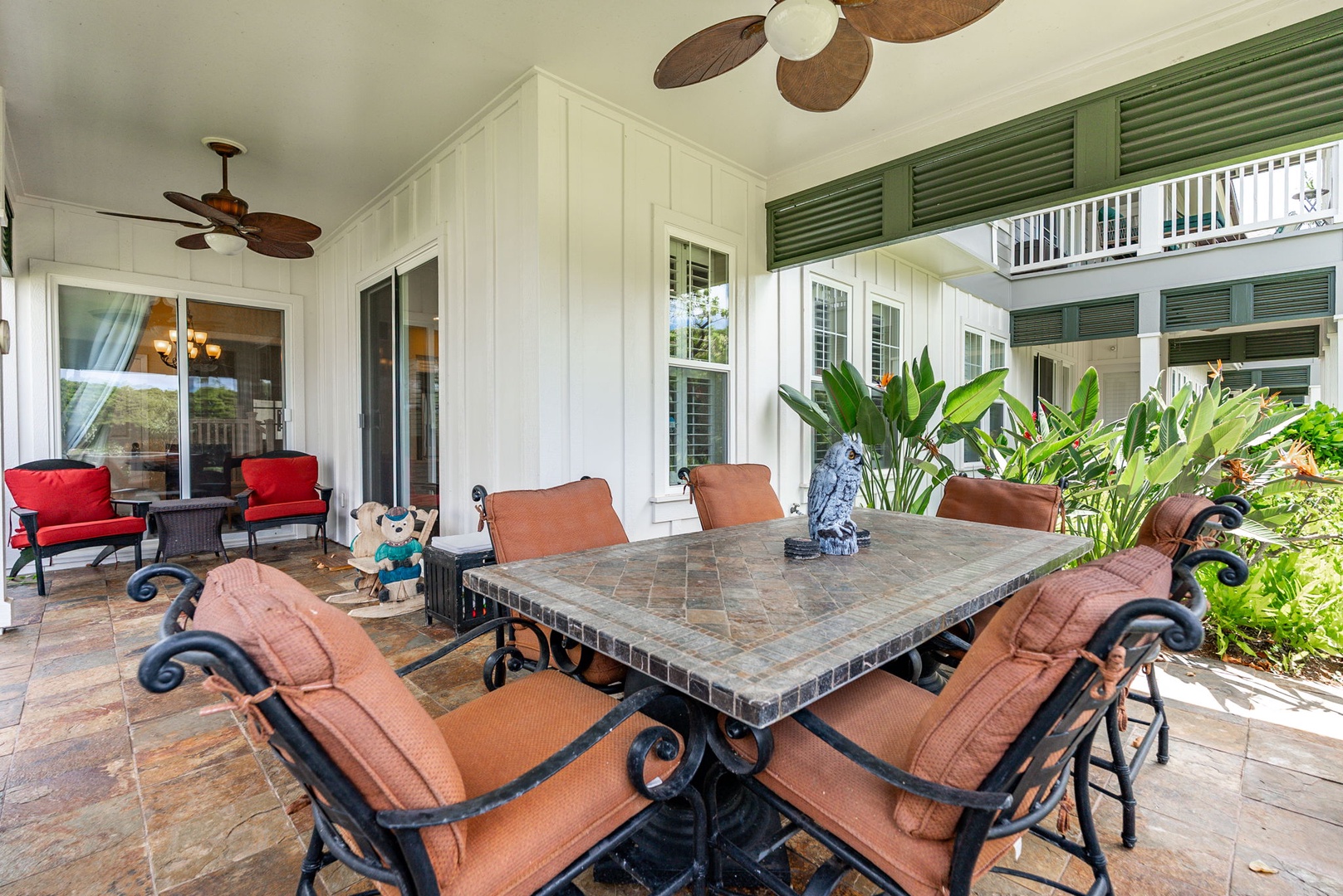 Kapolei Vacation Rentals, Coconut Plantation 1080-4 - Everyone finds a seat at the outdoor table, greenery close on every side.