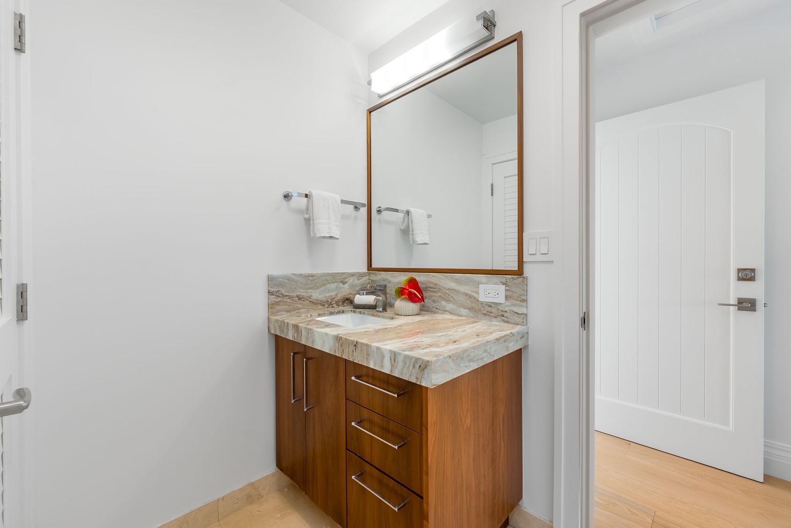 Kailua Vacation Rentals, Lanikai Sunrise Estate - Elegant ensuite bath with granite countertops and tropical wood cabinetry for a touch of refinement.