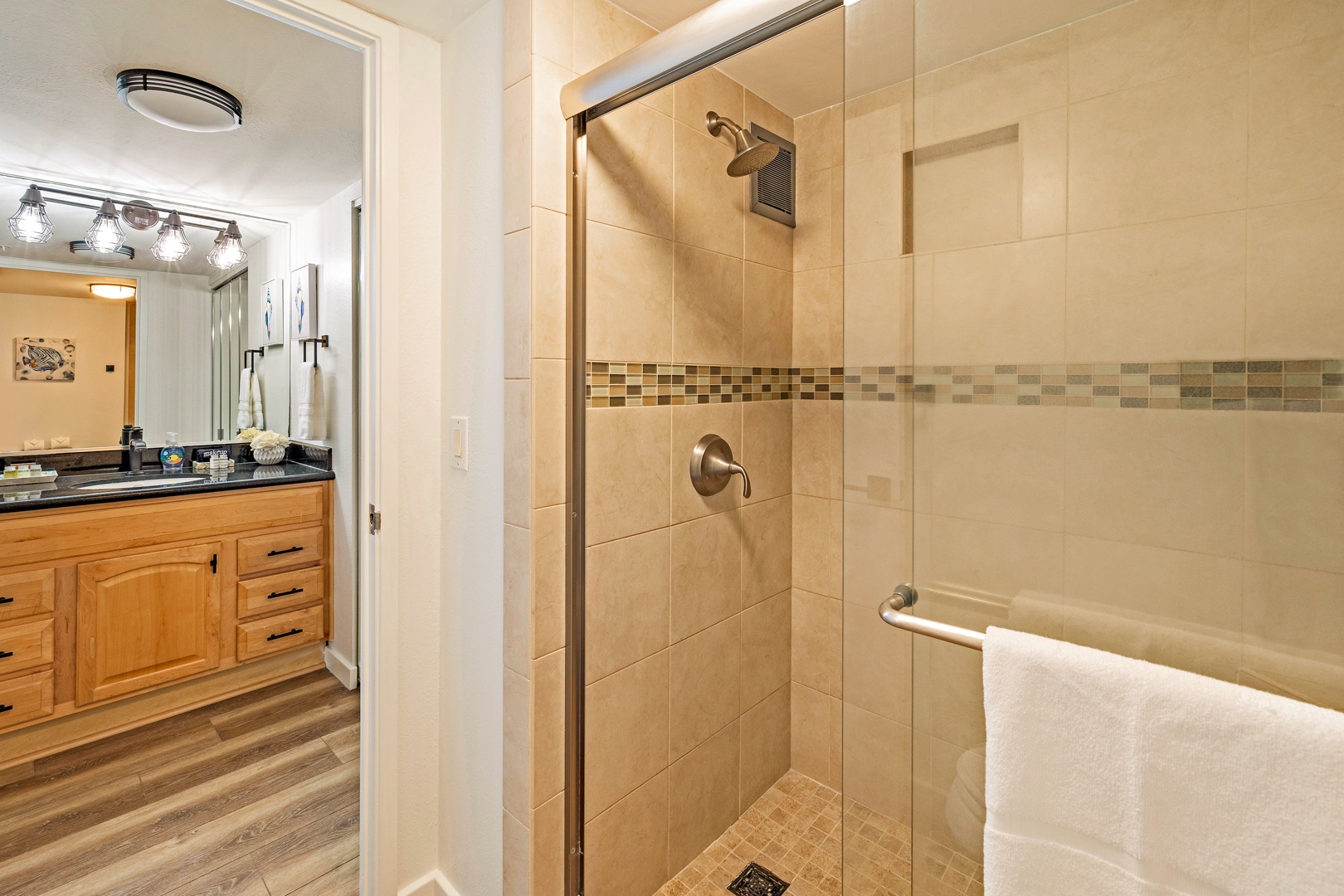 Lahaina Vacation Rentals, Mahana 718 - The bathroom showcases a modern walk-in shower with elegant tilework, offering a refreshing and luxurious experience.