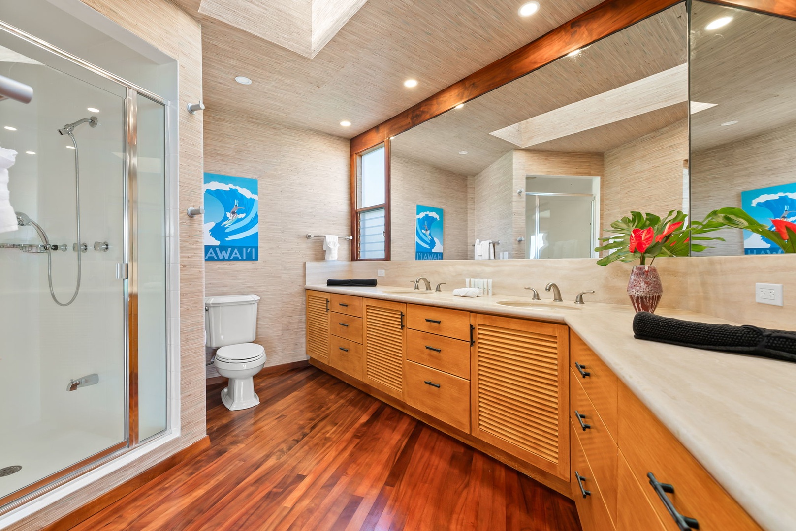 Honolulu Vacation Rentals, Black Point Ocean Villa - Luxurious bathroom featuring rich wood floors, stunning double vanities, and a spacious glass shower - your private spa retreat.