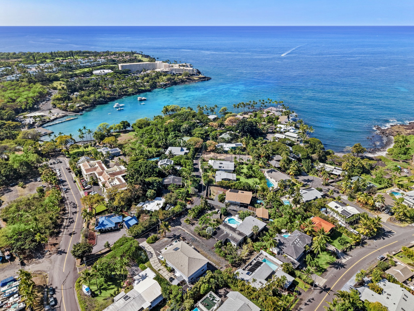 Kailua Kona Vacation Rentals, Mai Tai Manor - Stunning aerial view of oceanfront community with pristine turquoise waters and tropical landscape.