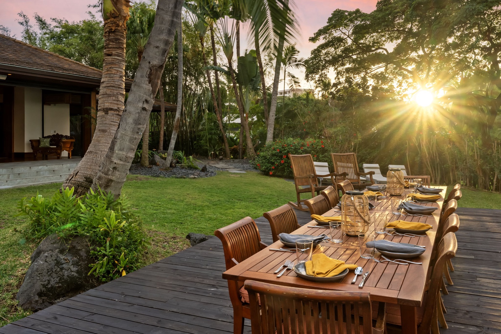 Kailua-Kona Vacation Rentals, Hahalua Bay Villa - Golden sunlight filters through palm trees over your private outdoor dining deck, where tropical garden views and warm evening breezes create unforgettable dinner moments.