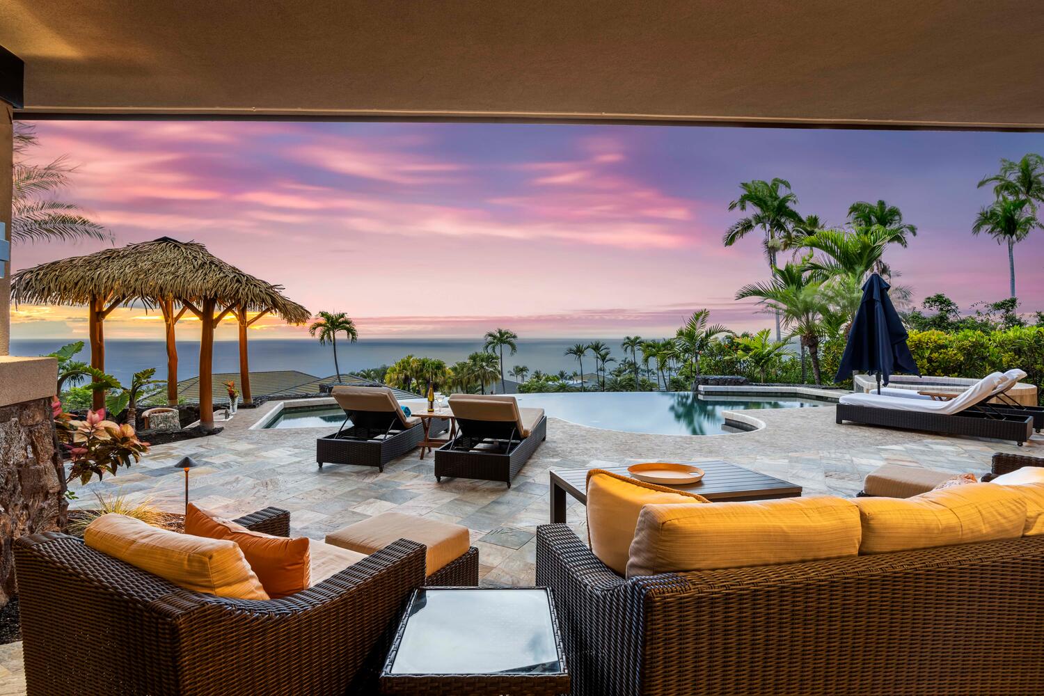 Kailua Kona Vacation Rentals, Island Oasis - Nestled under the evening sky, our poolside chaise lounges invite you to relax and savor the twilight hues.