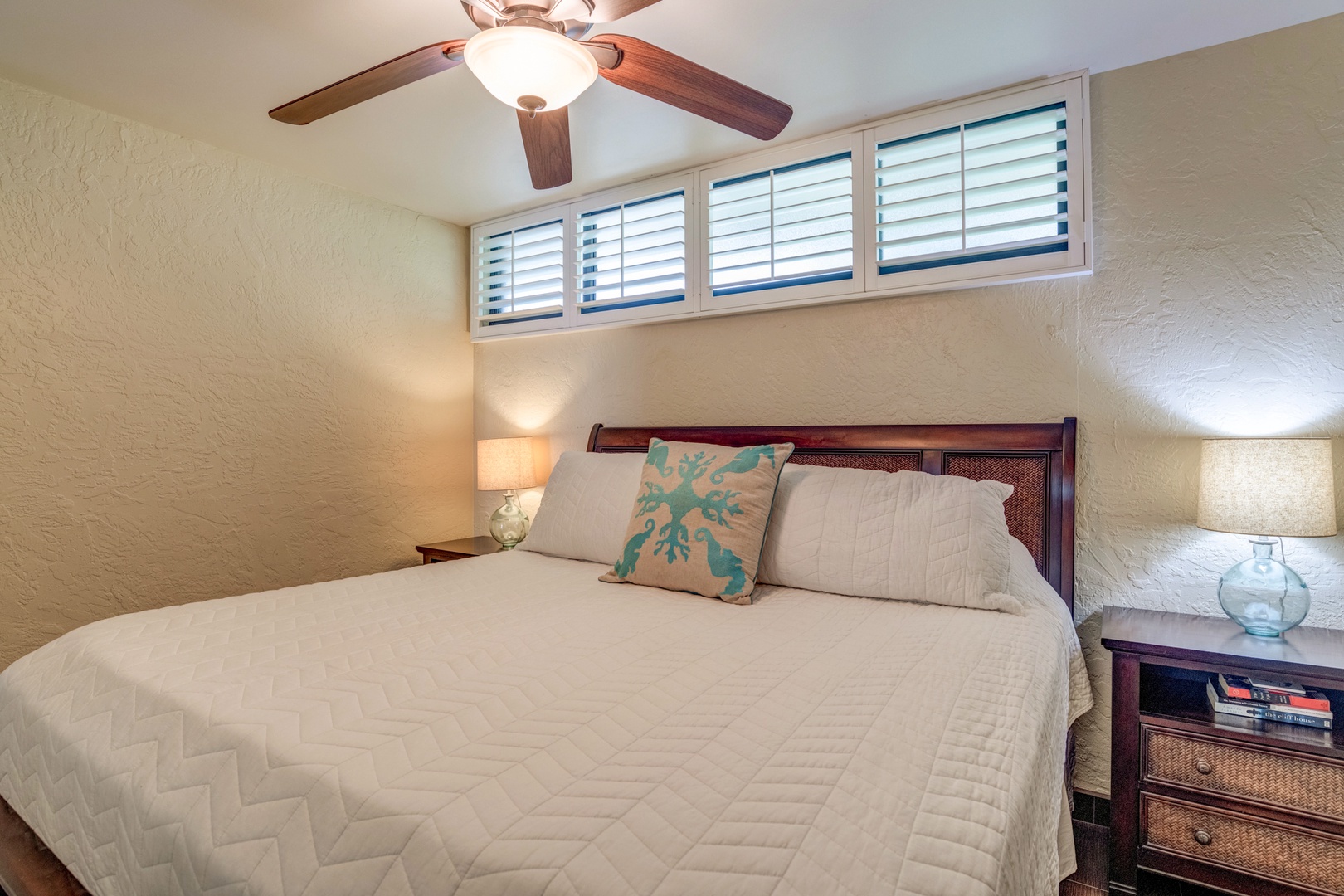 Lahaina Vacation Rentals, Papakea B-105 - The bedroom provides a serene retreat, with soft natural light filtering through the shutters and a cozy bed to ensure a restful night's sleep after exploring the island.