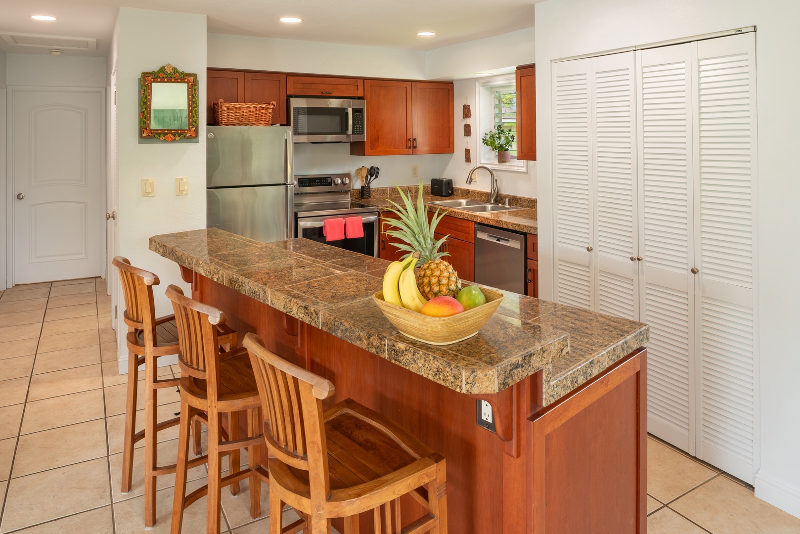 Princeville Vacation Rentals, Moana Kai - Morning coffee at the breakfast bar, close enough to keep talking while someone cooks.