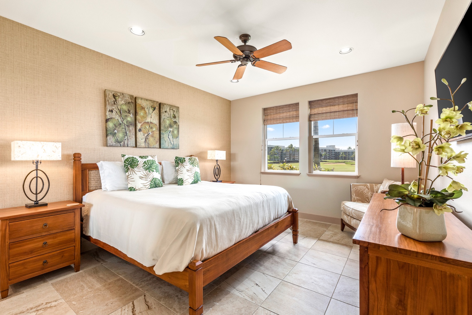 Waikoloa Vacation Rentals, 2BD Hali'i Kai (12C) at Waikoloa Resort - Primary bedroom with king bed, flat screen TV, ocean and golf course views and en suite bath.