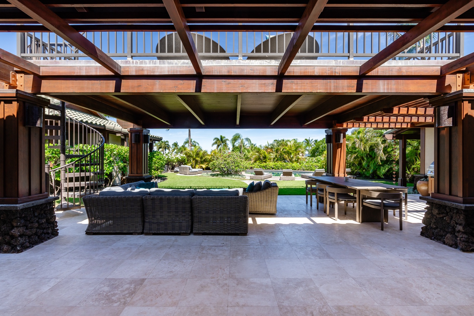 Kamuela Vacation Rentals, Beach Walker at Champion Ridge - Expansive lanai space with comfortable seating, a dining area, and views of the pool and garden