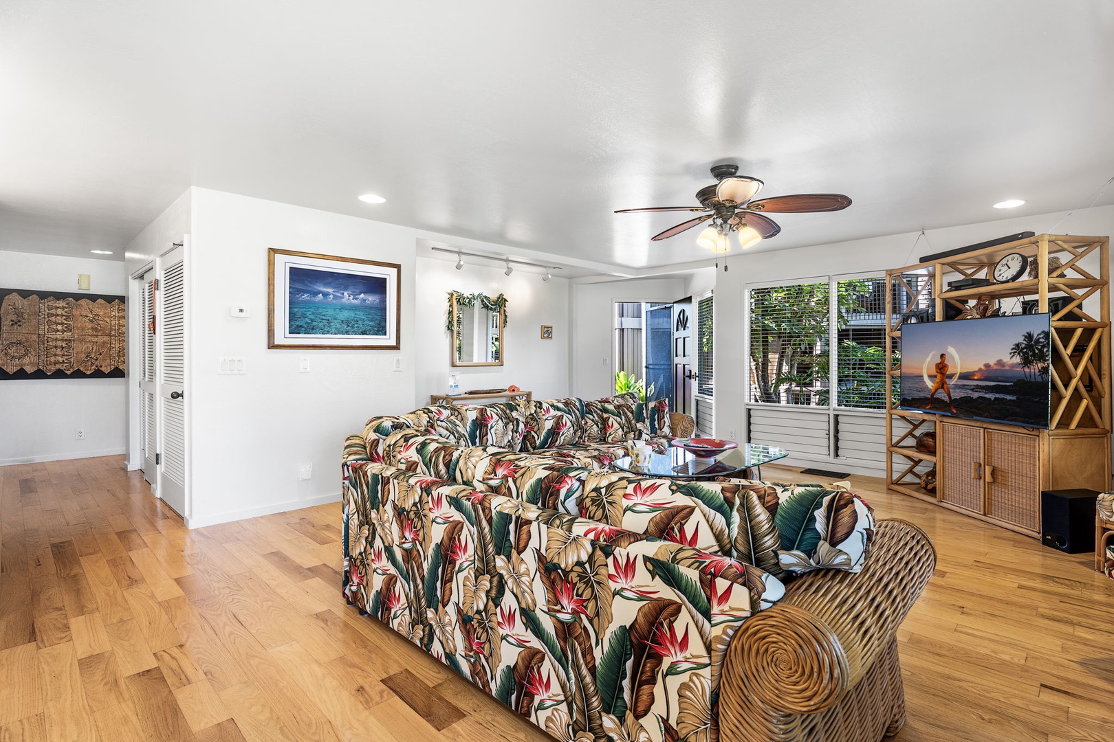 Kailua Kona Vacation Rentals, Kanaloa at Kona 701 - The living room with vibrant Hawaiian furnishings, ceiling fan, and entertainment center for cozy island evenings.