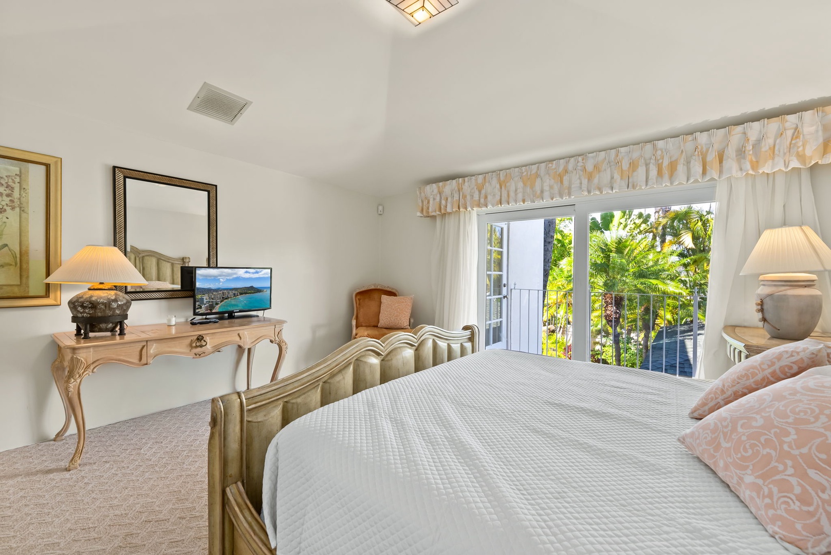 Honolulu Vacation Rentals, Kahala Oasis - Spacious guest suite with access to a balcony, letting in natural light and offering beautiful outdoor views.