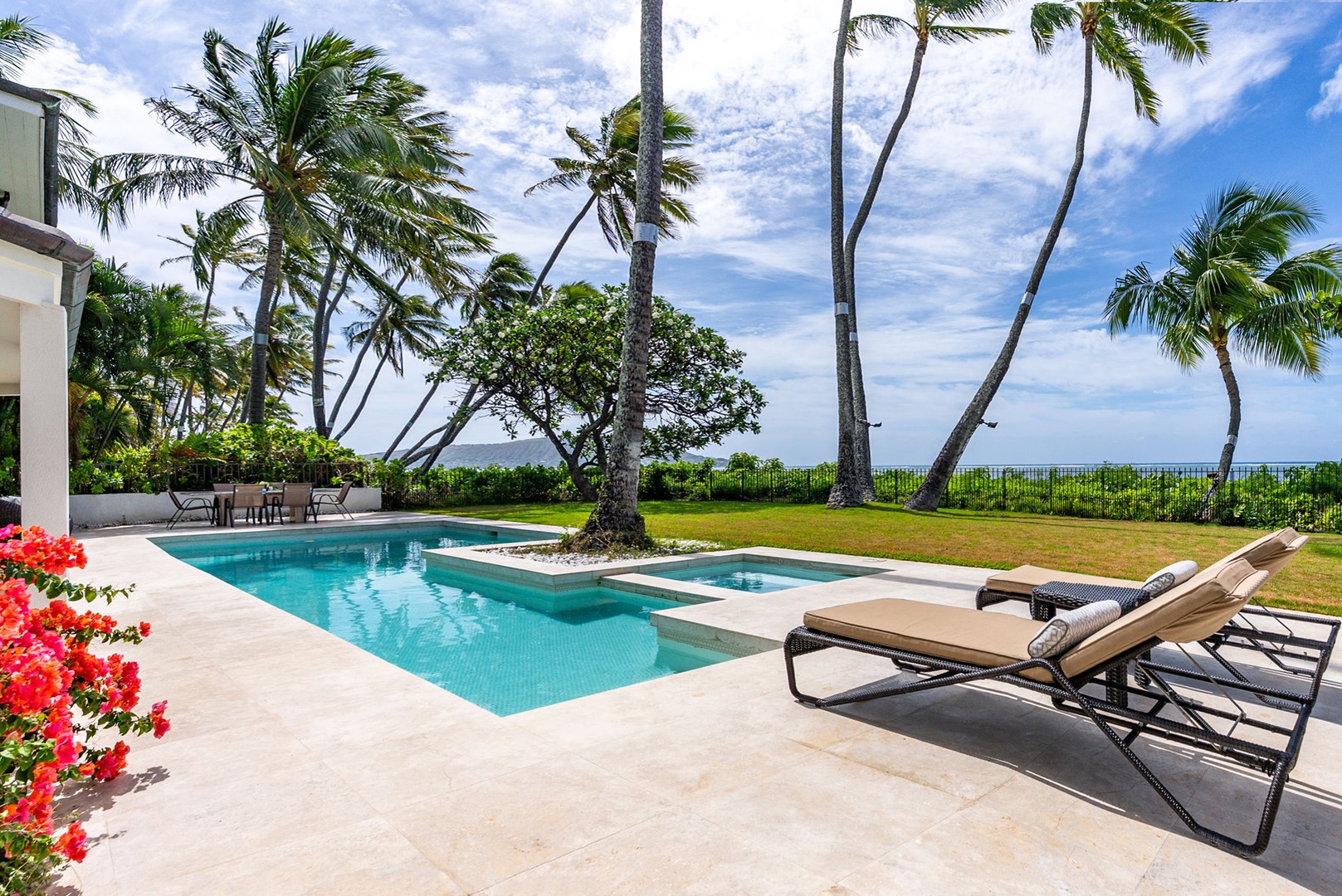 Honolulu Vacation Rentals, Paradise Beach Estate - Relax poolside under palm trees with plush loungers, perfect for sunbathing, reading, or simply unwinding by the water.