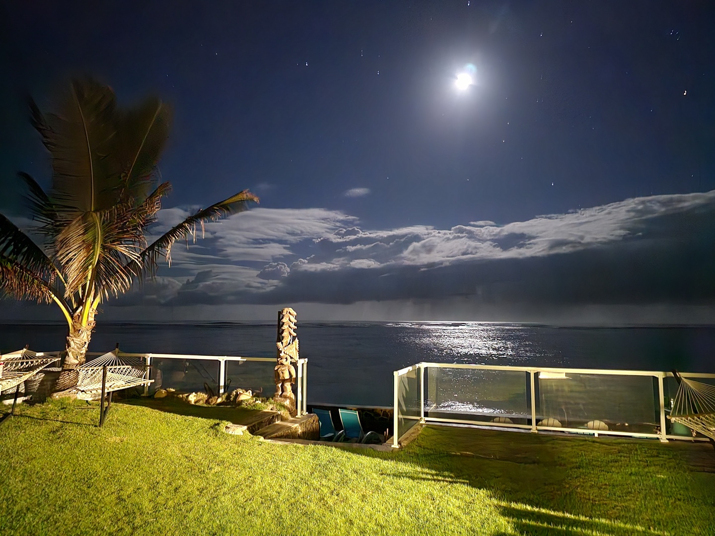 Hauula Vacation Rentals, Private Beach Paradise - Moonlight lays a path across the water, seen from the edge of the lawn.