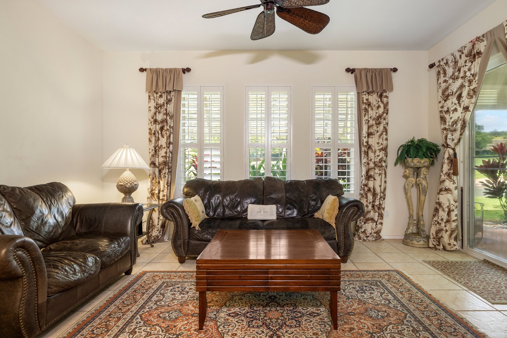 Kapolei Vacation Rentals, Coconut Plantation 1150-2 - Sink into plush leather sofas where afternoon light filters through plantation shutters, creating your perfect retreat for relaxation.