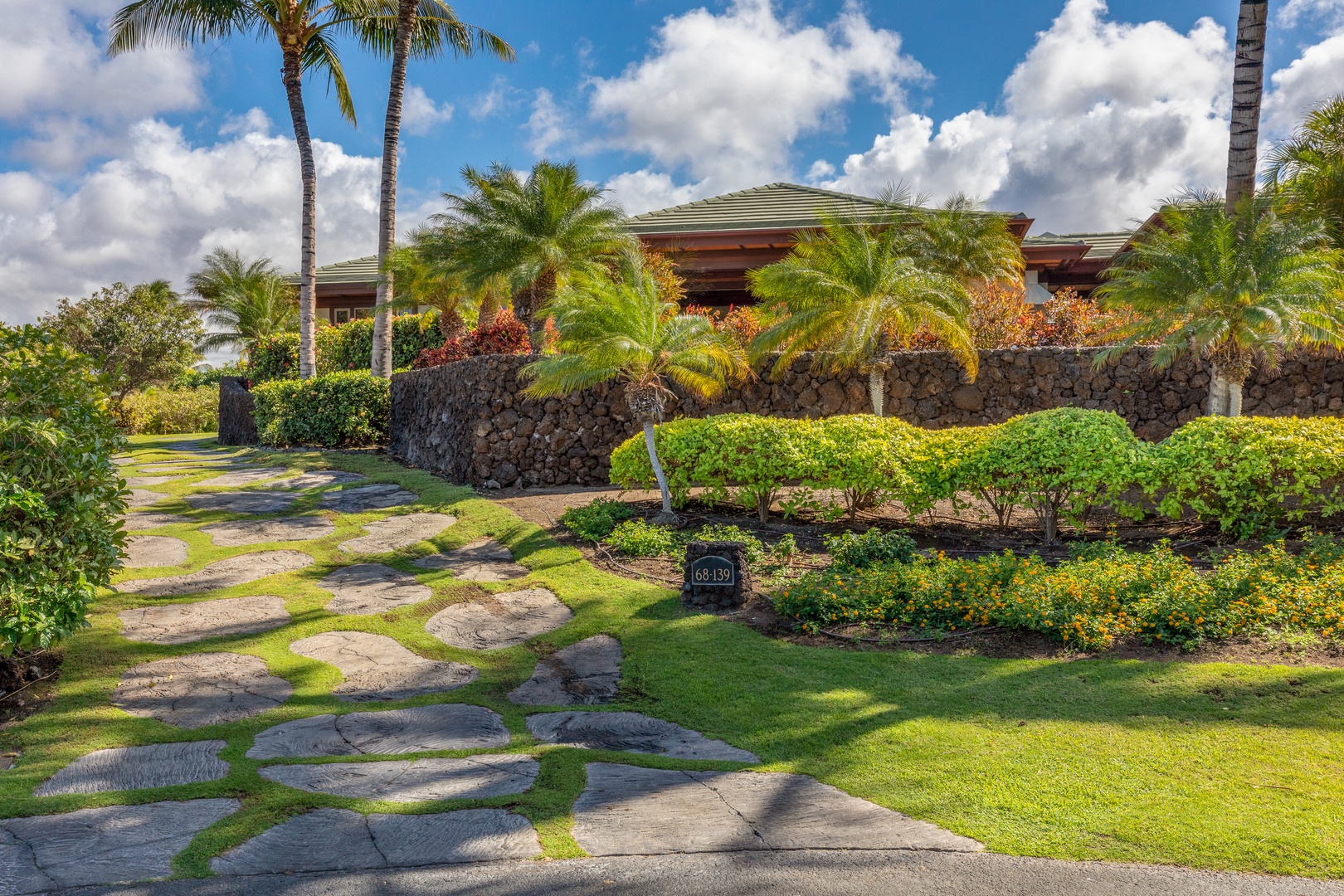 Kamuela Vacation Rentals, Champion Ridge Home - Inviting guest entry with tropical stone steps and vibrant greenery.
