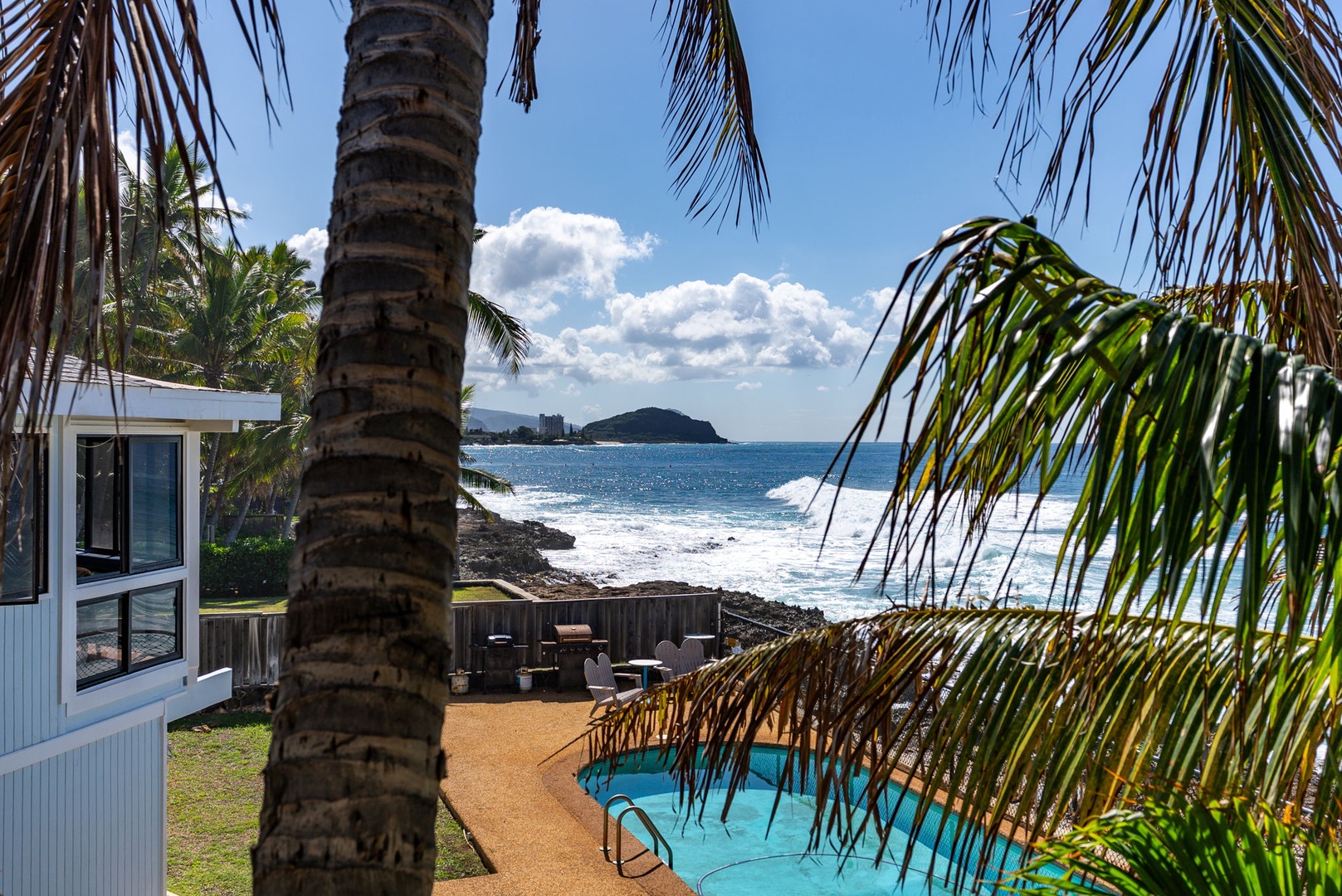 Waianae Vacation Rentals, Oceanfront Luxury Dream Estate - Soak in ocean serenity beside the sparkling pool framed by lush tropical palms.