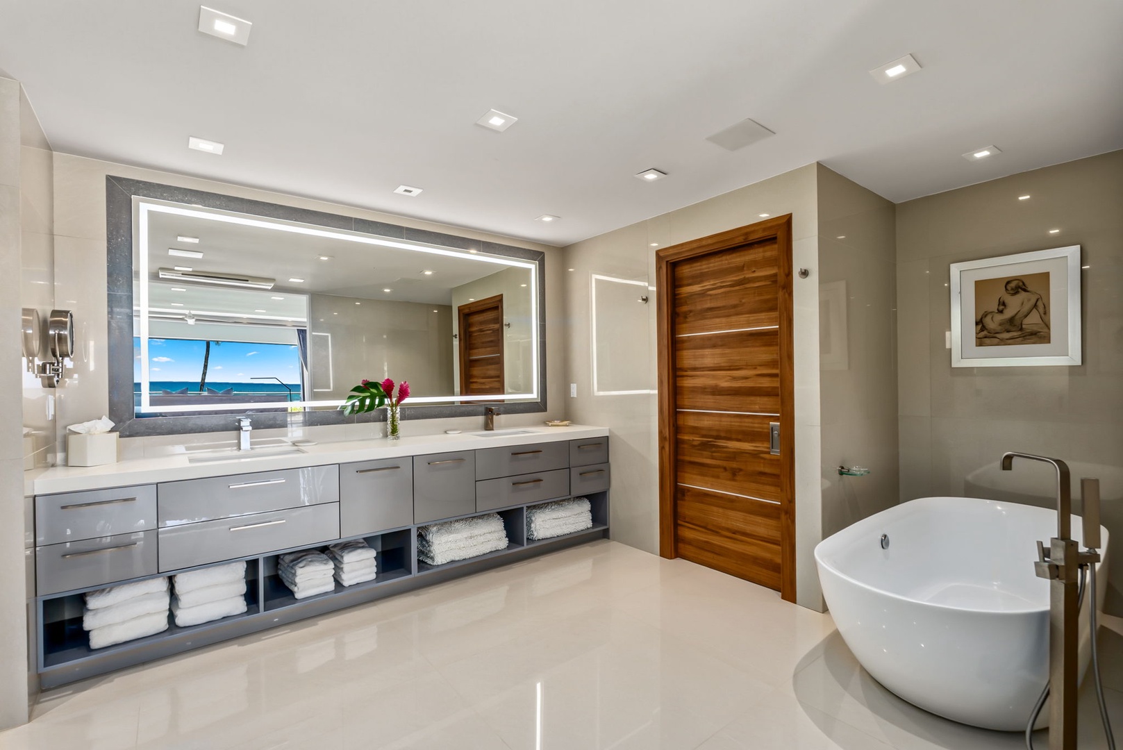 Honolulu Vacation Rentals, Diamond Head Beachfront Estate - Picture yourself unwinding in this spa-like bathroom, where a luxurious soaking tub and ocean-view vanity create your perfect coastal retreat.