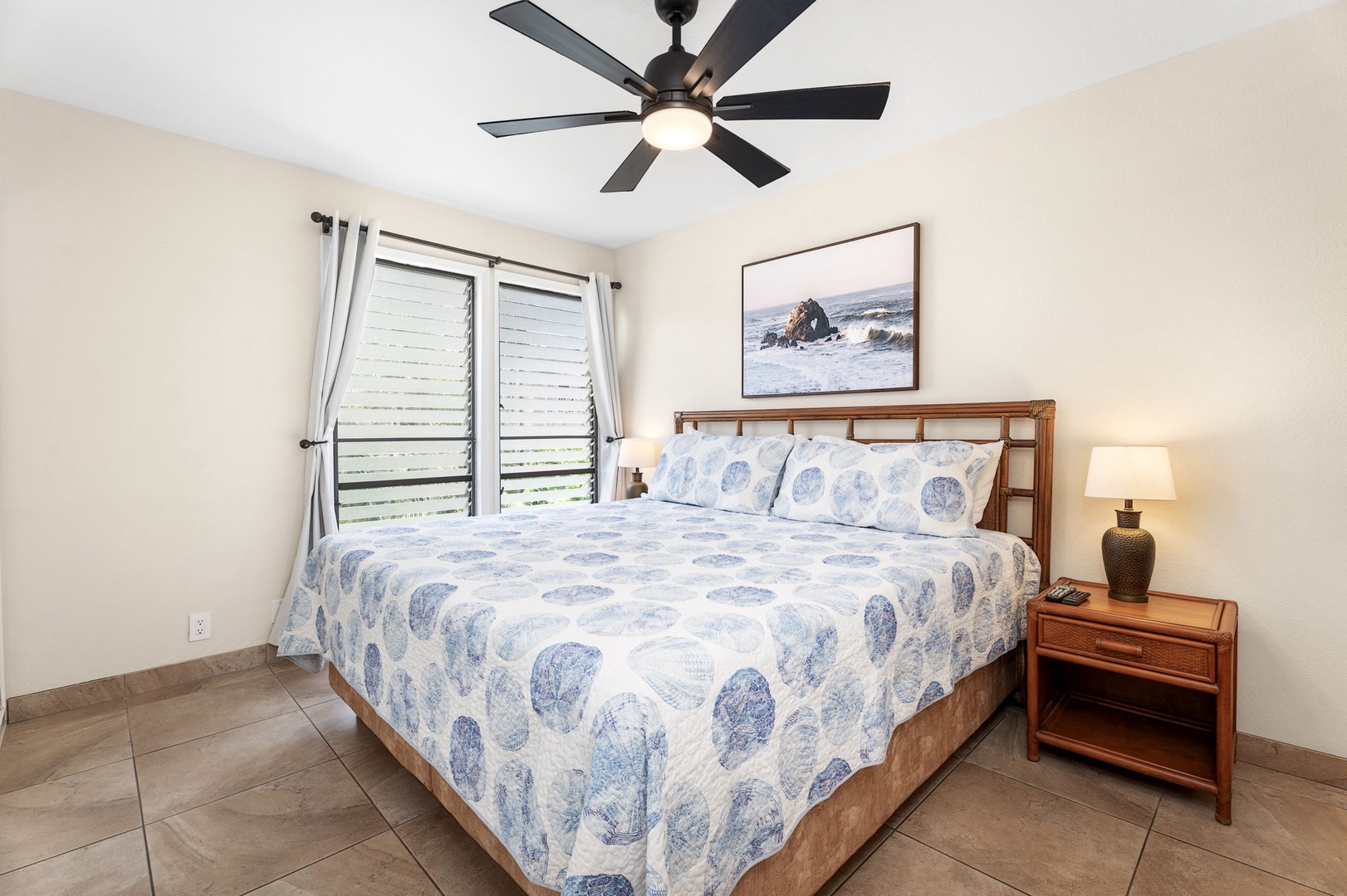 Kailua Kona Vacation Rentals, Sea Village 4213 - Primary bedroom with king-size bed, ceiling fan, and tropical accents—your serene ocean retreat.