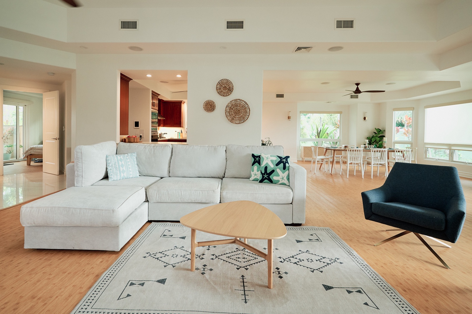 Princeville Vacation Rentals, Hale Kai - Unwind in your spacious living room where modern comfort meets style - sink into the plush sectional while natural light streams through.