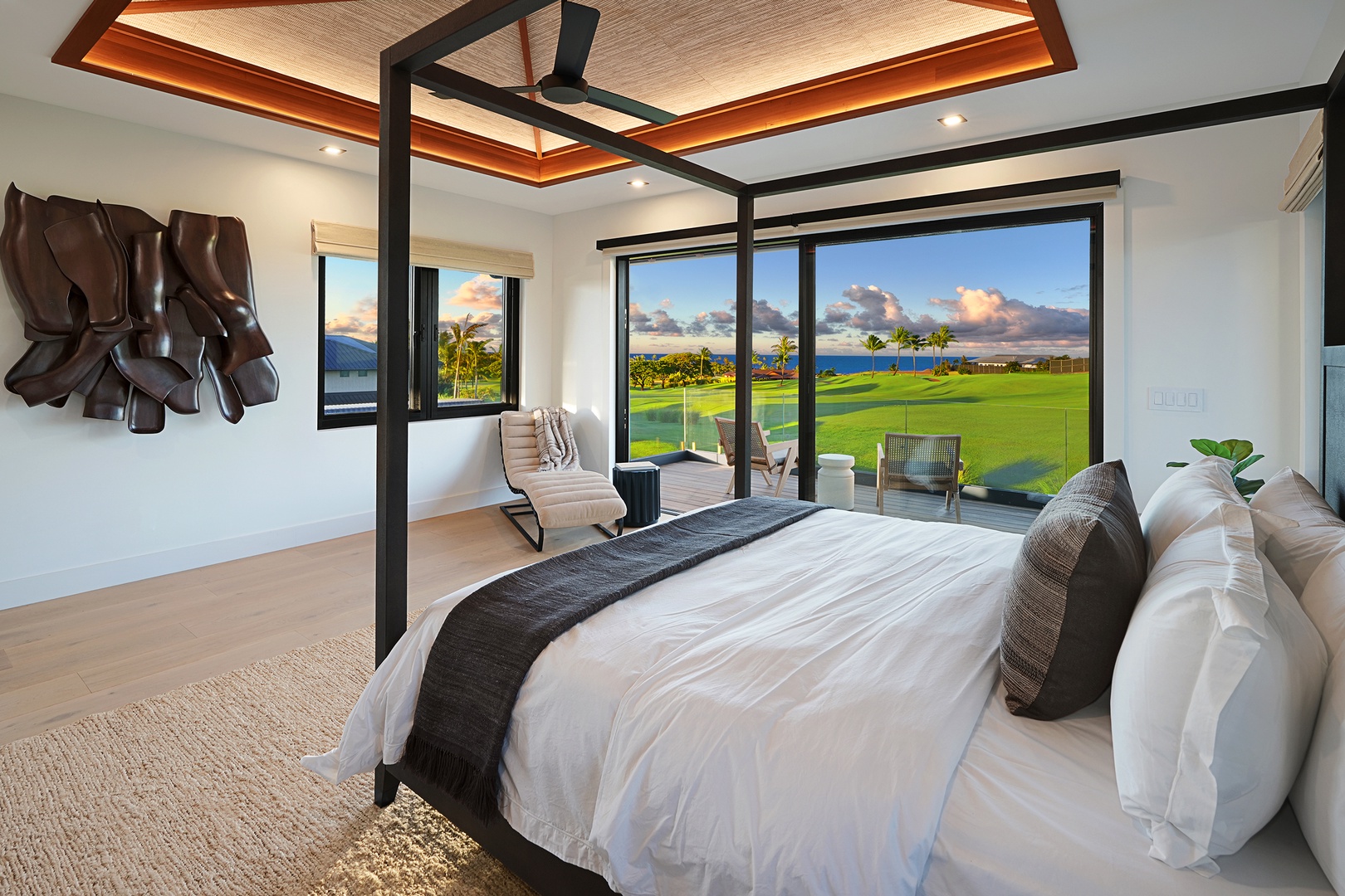 Koloa Vacation Rentals, Hale Hanohano - Primary suite with canopy bed, golf and ocean views, and lanai access.