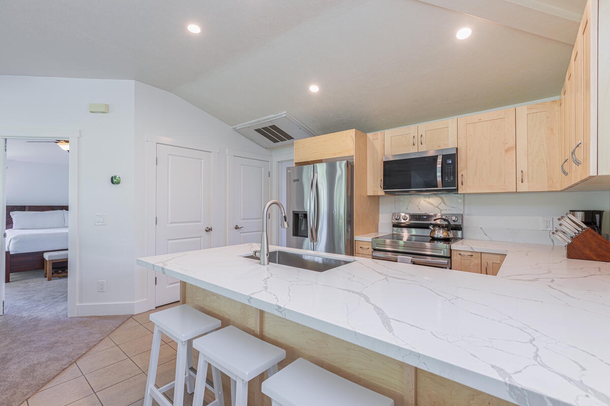 Princeville Vacation Rentals, Pili Aloha - Open kitchen featuring a breakfast bar, good for 4.