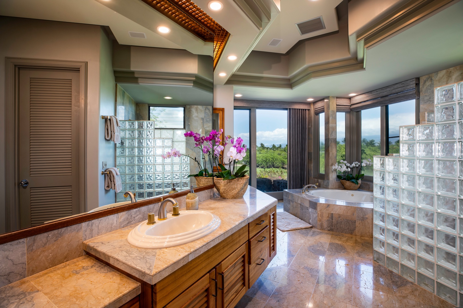 Kamuela Vacation Rentals, Canoe House at Champion Ridge - Elegant bathroom with dual sinks, a large mirror, and a window view.