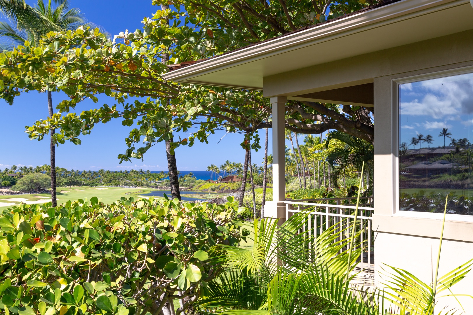 Kailua Kona Vacation Rentals, 3BD Waiulu Villa 111D at Hualalai Resort - Serene balcony view surrounded by lush greenery and vibrant tropical landscapes.