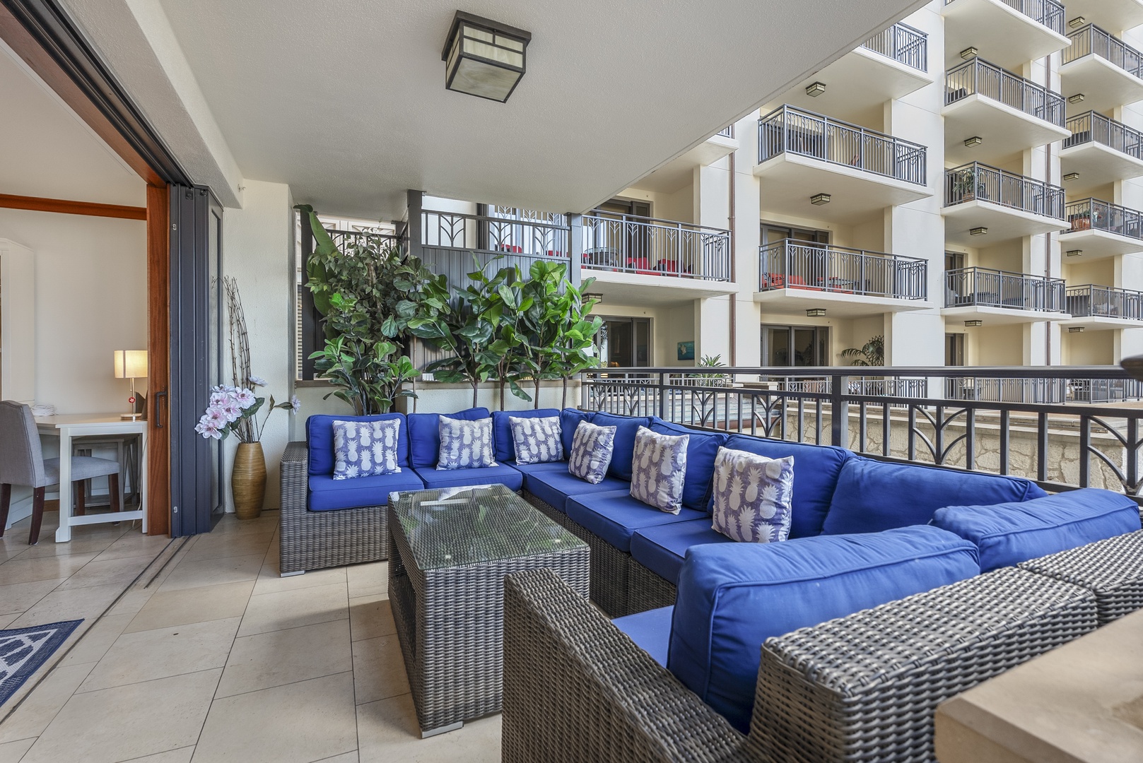 The blue wicker sectional on the lanai is where the group lands after every beach day.