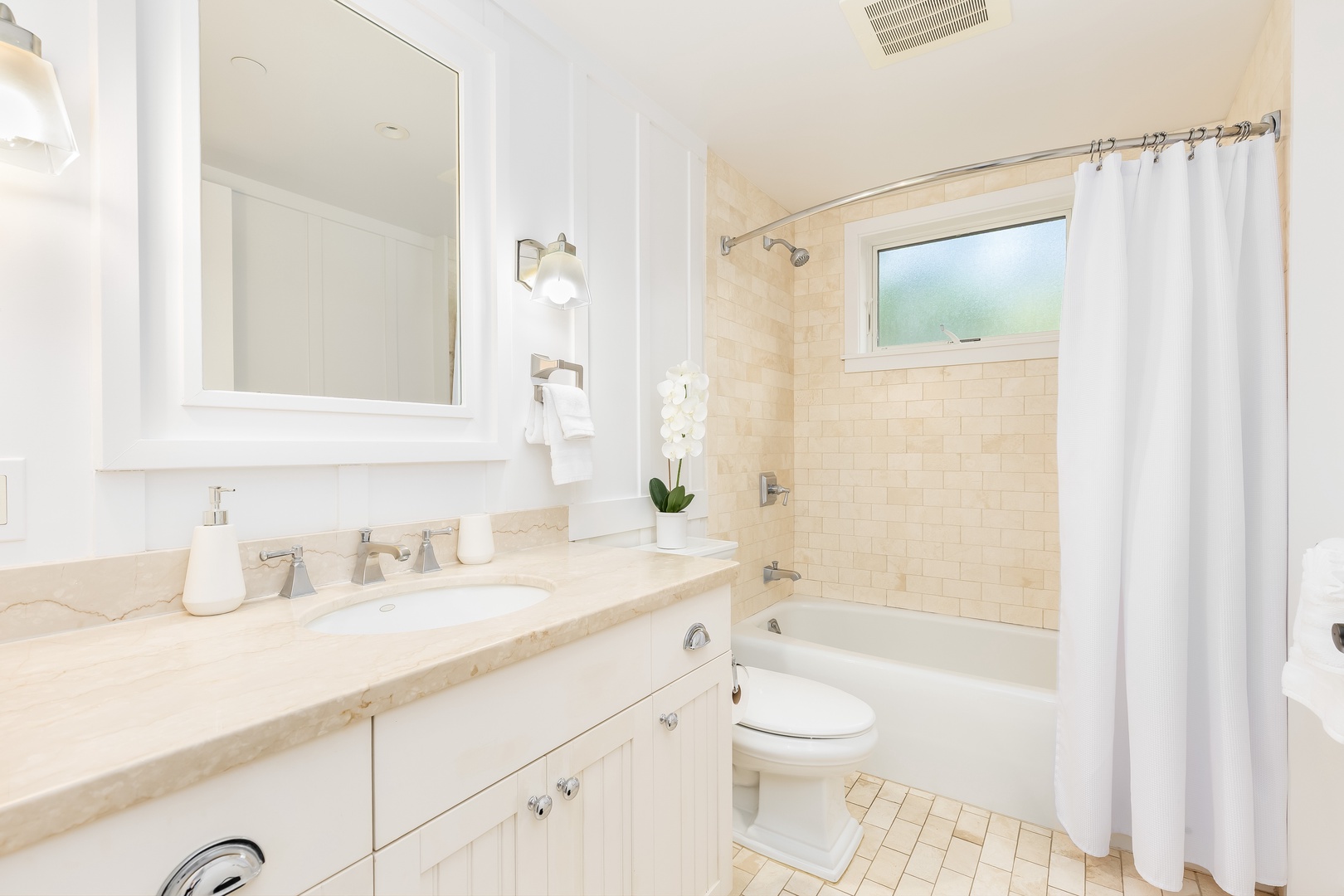 Kahuku Vacation Rentals, Turtle Bay Villas 209 - Your spa-like bathroom features marble countertops, a deep soaking tub, and fresh white linens—perfect for unwinding after your adventures.